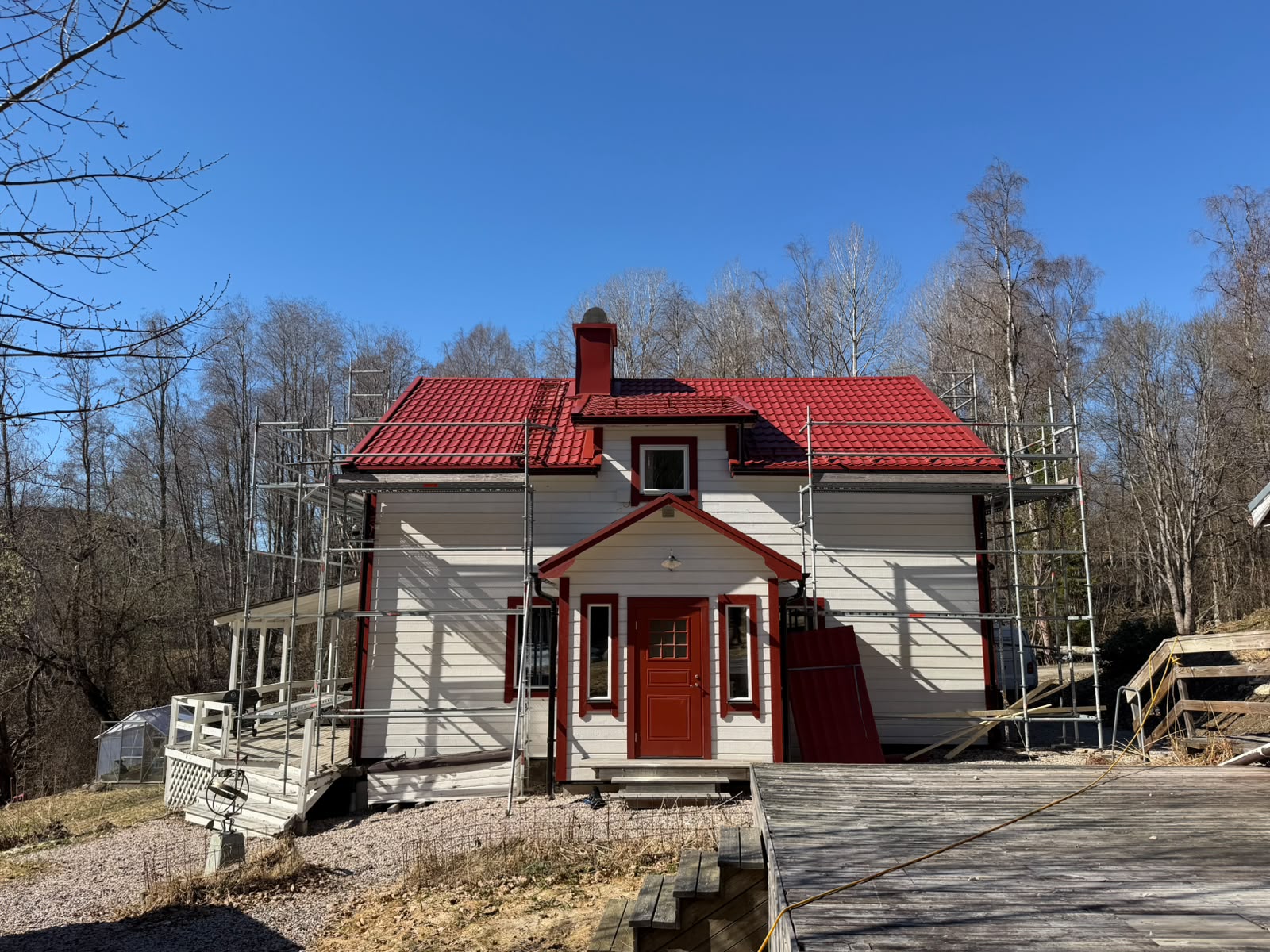Villa med nytt rött tak och byggnadsställning